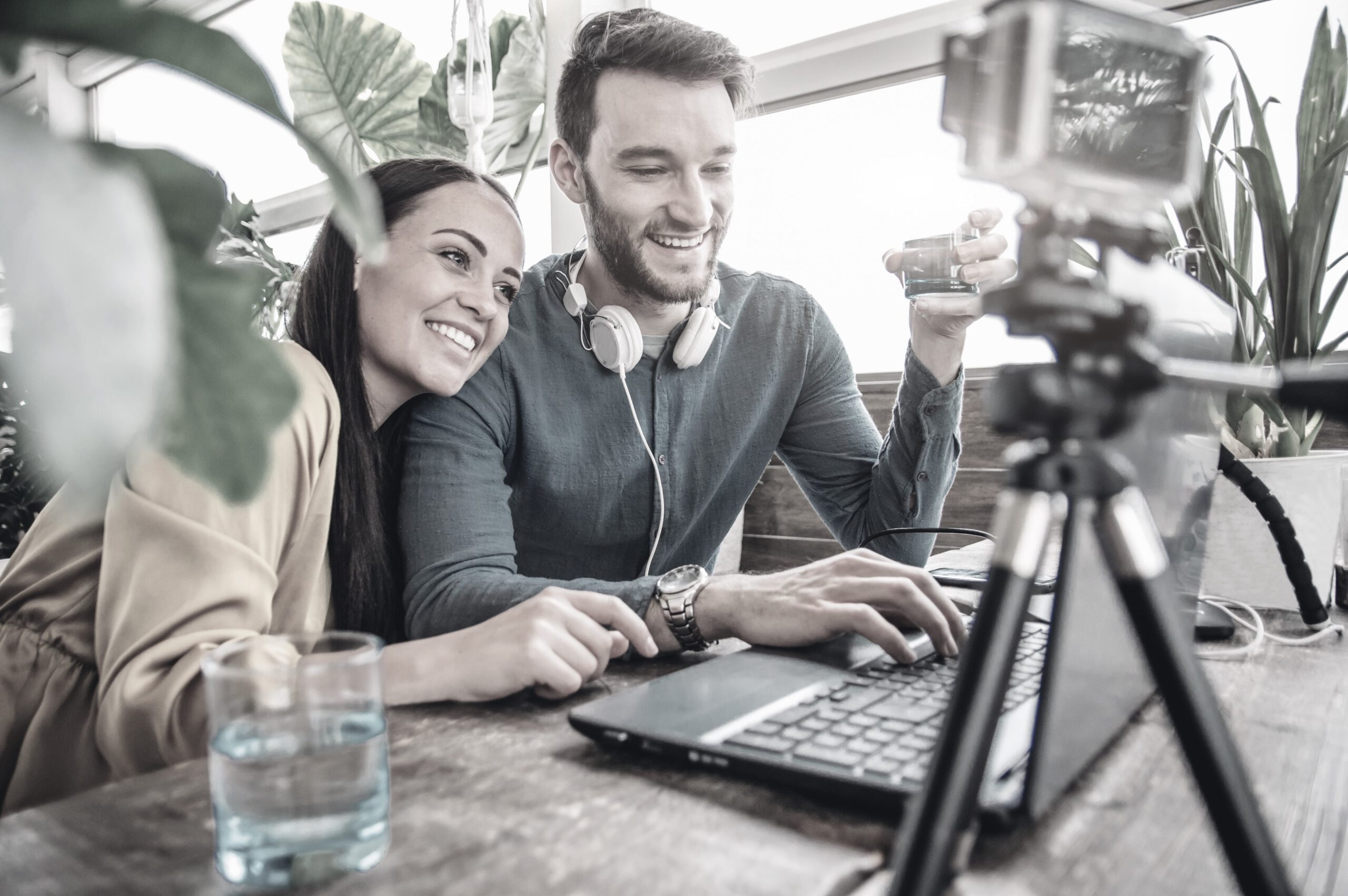 Happy couple of bloggers recording a video preparing to post in